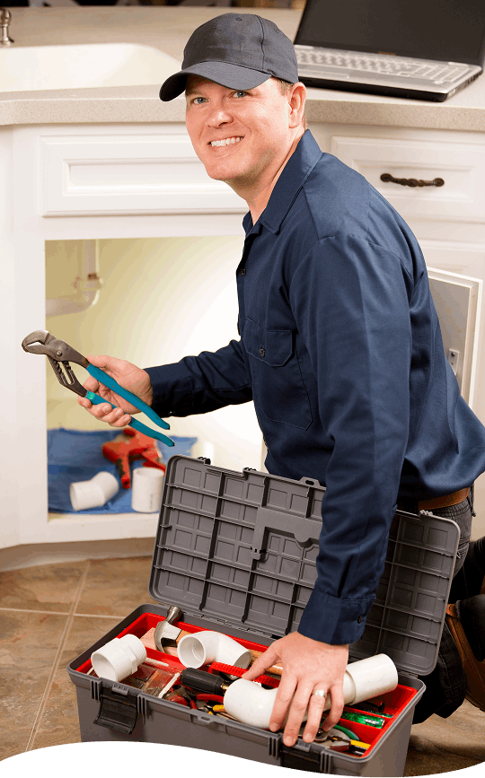 Plumbing technician working under a sink