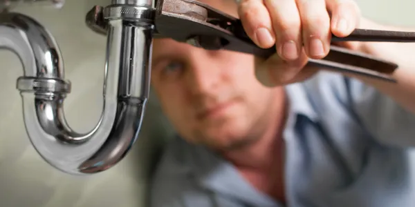 plumber repairing sink drain
